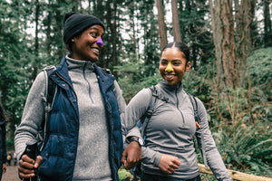 Two women wearing sunscreen going on a hike together. 